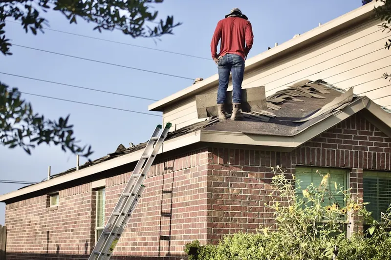 Professional roofer working on a residential roof in Rosecroft Park